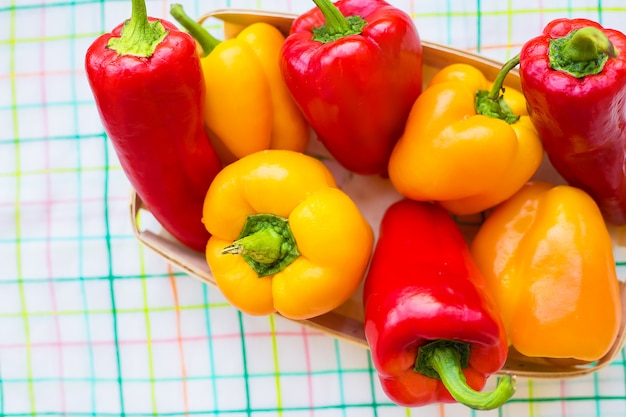 Yellow and red peppers closeup on colorful napkin