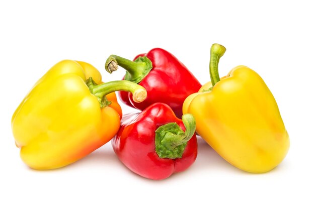 Yellow and red sweet peppers on white