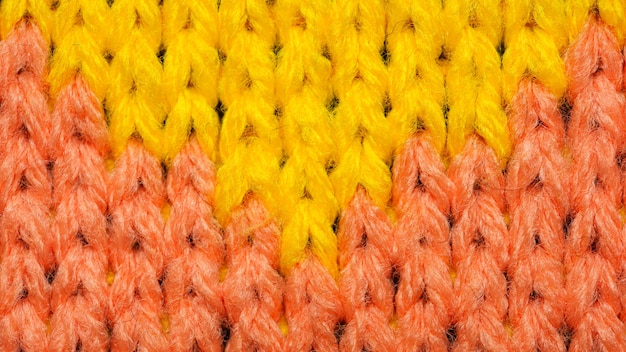 Yellow and red synthetic knitted fabric close up. Knitted fabric texture. Background