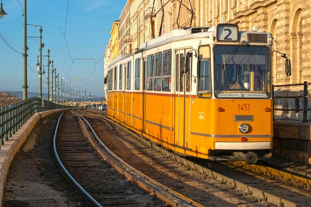 Yellow retro tramway number 2 in a street of Budapest