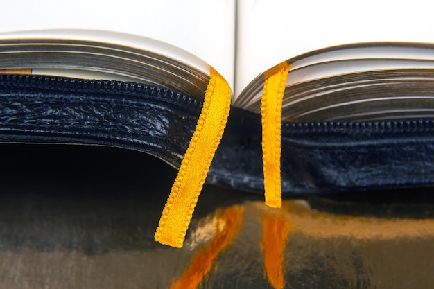 Yellow ribbon bookmark for a book Open bible The study of literature