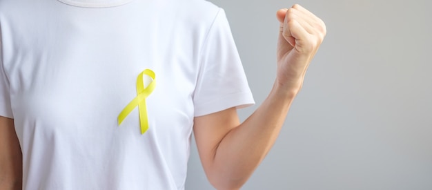 Yellow ribbon for supporting people living and illness.\
september suicide prevention day, childhood, sarcoma and bone\
cancer awareness month concept