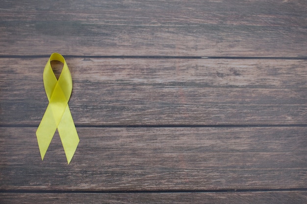 Photo yellow ribbon symbolic color for sarcoma bone cancer background