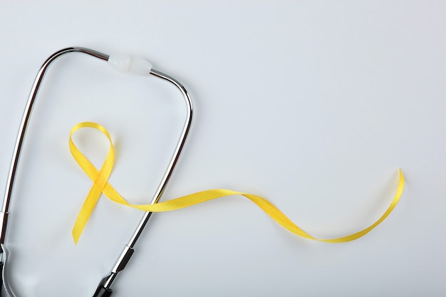 Yellow ribbon symbolizing cancer in children top view