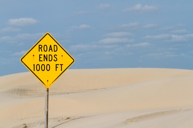 Yellow road sign at the end of the road.