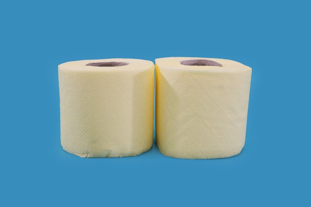 Yellow rolls of toilet paper on a blue background.