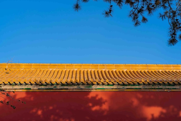 A yellow roof with a blue sky behind it