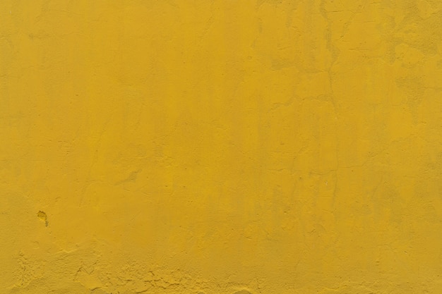 Yellow rough concrete wall texture background. Yellow cement vintage abstract background. Empty wall space for text.