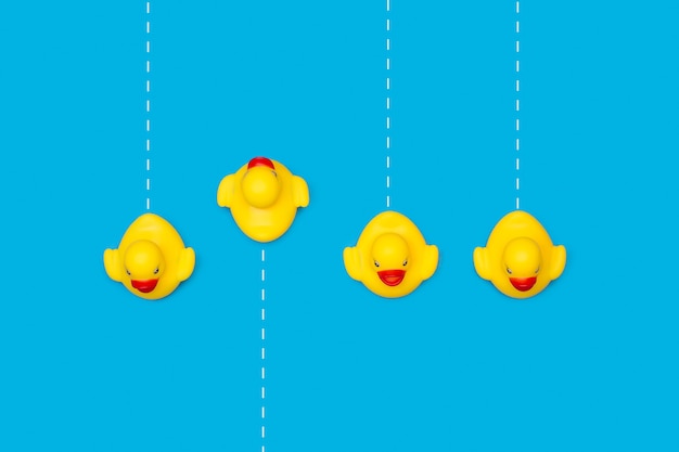 Yellow rubber toy ducks on blue with dashed white lines