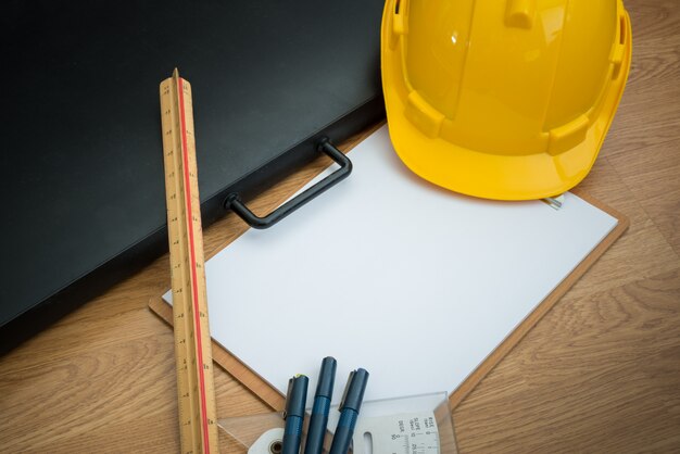 Yellow Safety Helmet Hat and clipboard