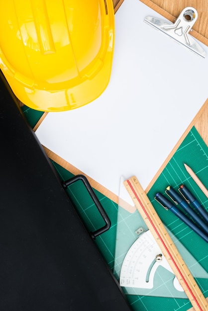 Yellow Safety Helmet Hat and clipboard