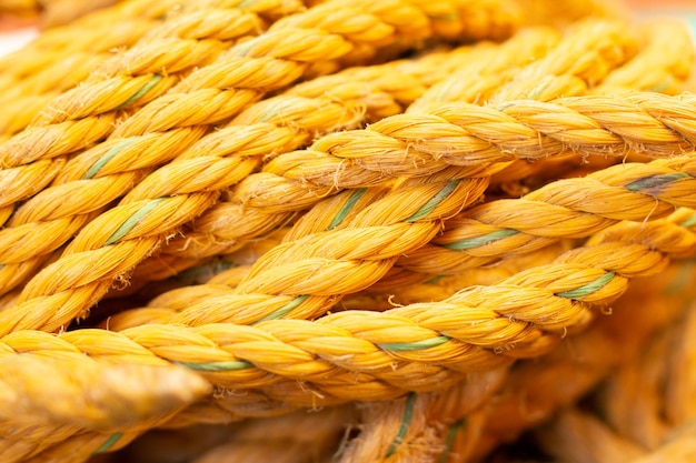 Yellow safety rope made of strong fibers Closeup of used bright yellow ropes Wallpaper