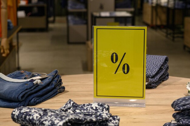 Yellow sale sign in the cloth shop