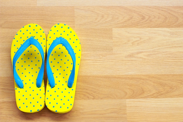 Yellow sandals on wooden background