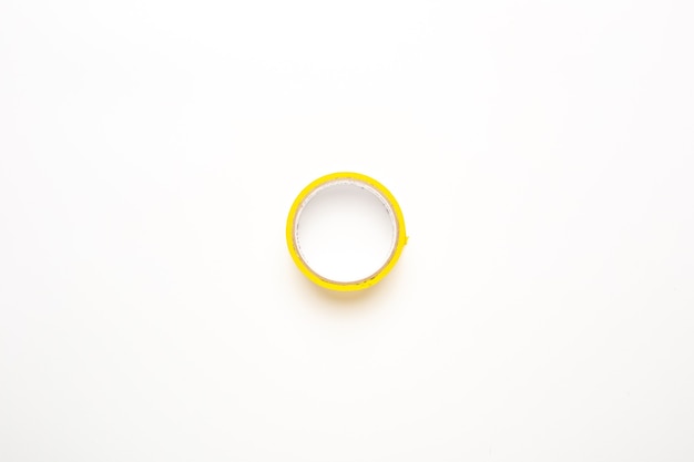 Yellow scotch tape on a white background. Adhesive tape. Top view, flat lay.