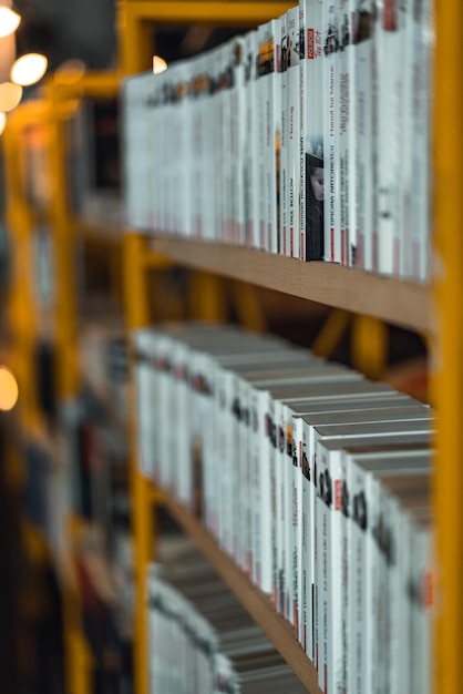 A yellow shelf with books on it that says the book's name is on the top shelf