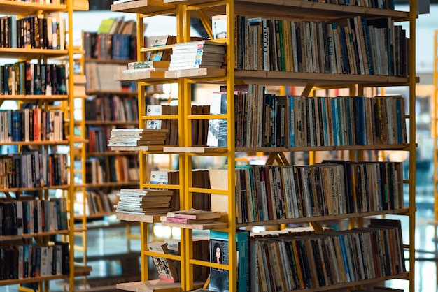 A yellow shelf with books on it that says the book's name is on the top shelf