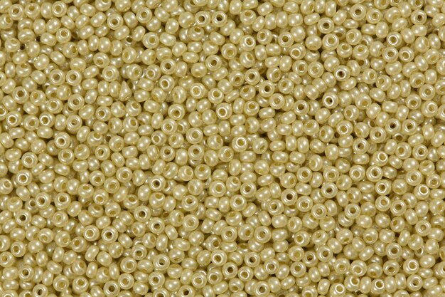 Yellow shining beads texture. High resolution photo