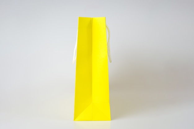 Yellow shopping bag one white background and copy space for plain text or product