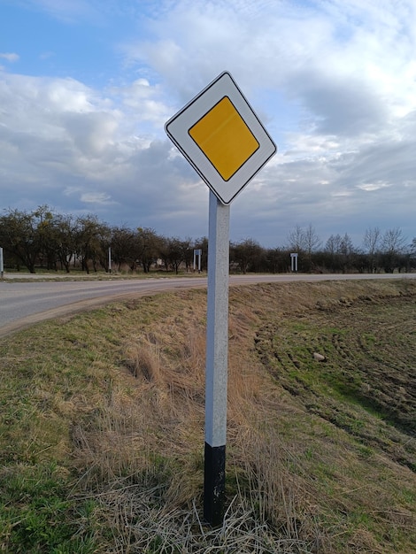 A yellow sign on a road that says'i'm not allowed to drive '