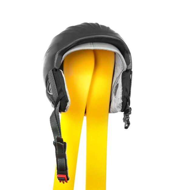 Photo yellow skis with helmet on white background winter vacation concept