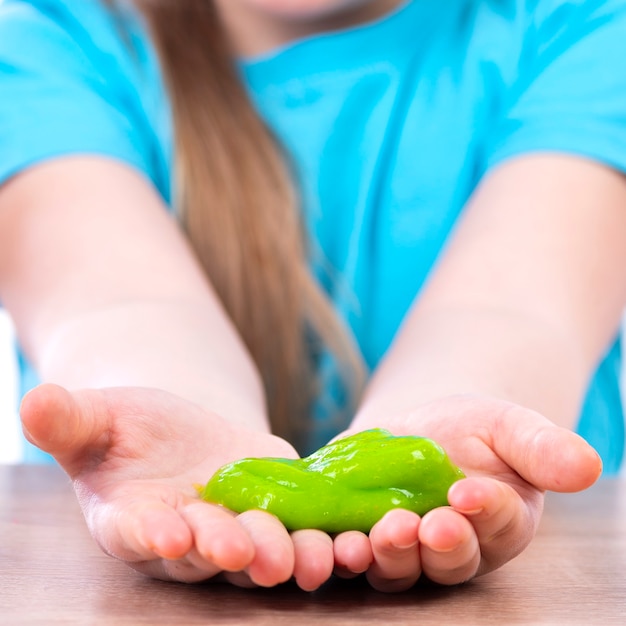 A yellow slime in the hands of a child