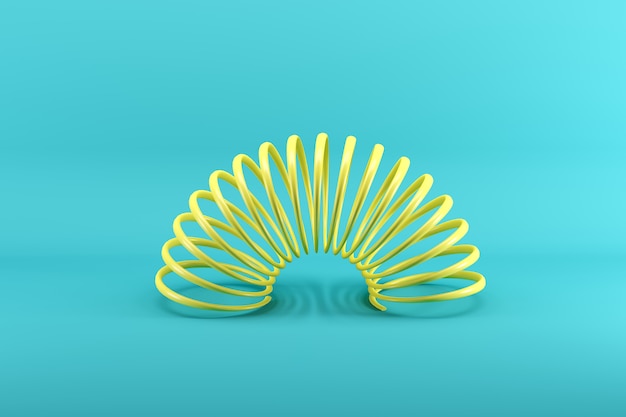 Yellow slinky isolated on blue 