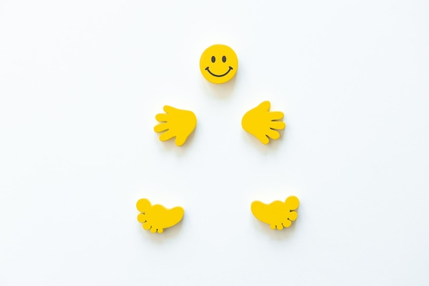 Yellow smile with hands and legs on white background