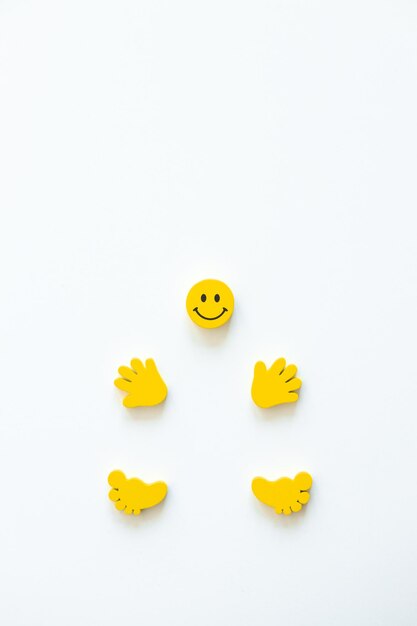 Yellow smile with hands and legs on white background