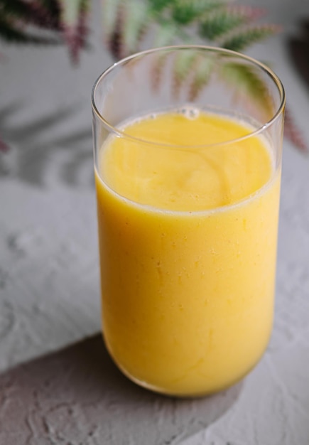 Yellow smoothie of mango banana and orange