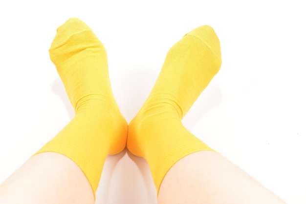 Yellow socks on woman foot isolated on white background