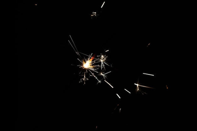 Yellow spark of sparkler on a black background