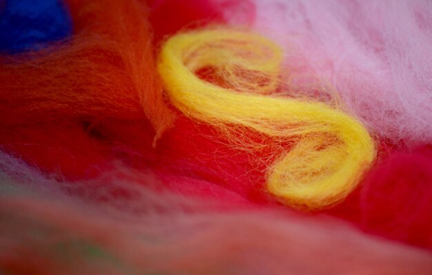 Photo yellow spiral of wool on a red