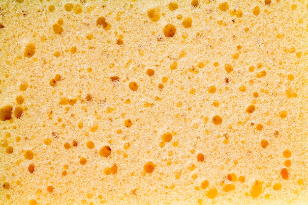 Yellow sponge for washing dishes and other items, closeup of kitchen sponges