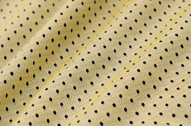 Yellow sport jersey clothing fabric texture and background with many folds