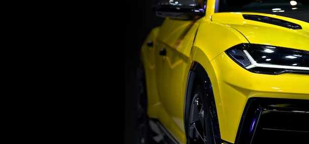 Yellow sports car is shown on a black background