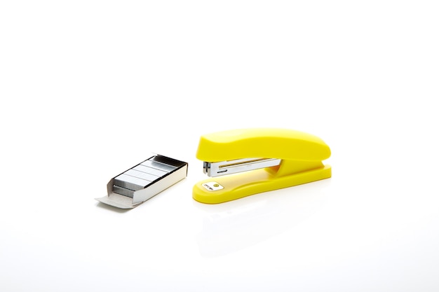 Yellow stapler on the white