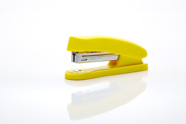 Photo yellow stapler on the white