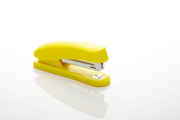 Yellow stapler on the white