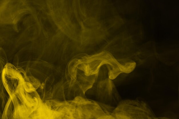 Yellow steam on a black background Copy space