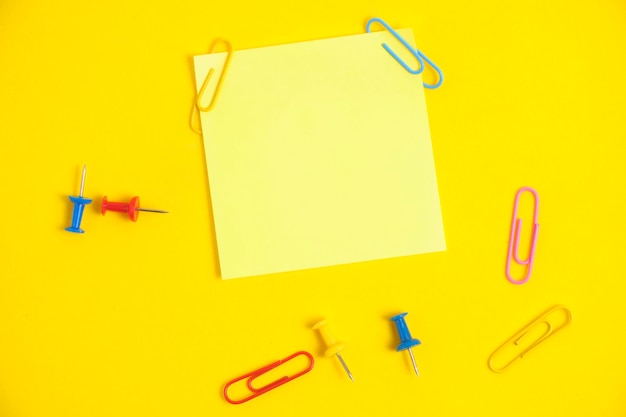 Yellow sticker for notes and stationery buttons with paper clips yellow background