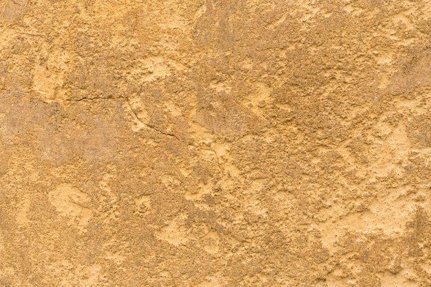 Foto superficie di pietra gialla con una crepa