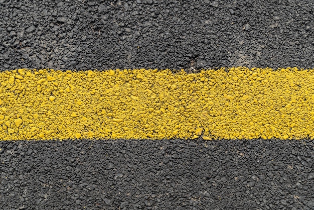 Yellow strip road markings on asphalt