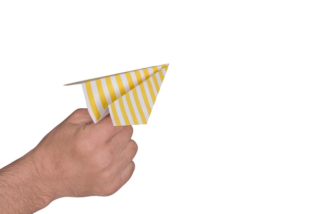 흰색 배경에 고립 된 성인 남자의 손에 노란색 줄무늬 종이 비행기.