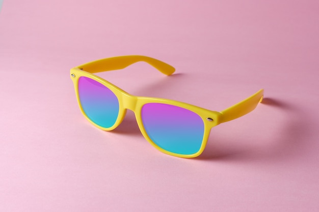 Yellow sunglasses isolated on pastel pink