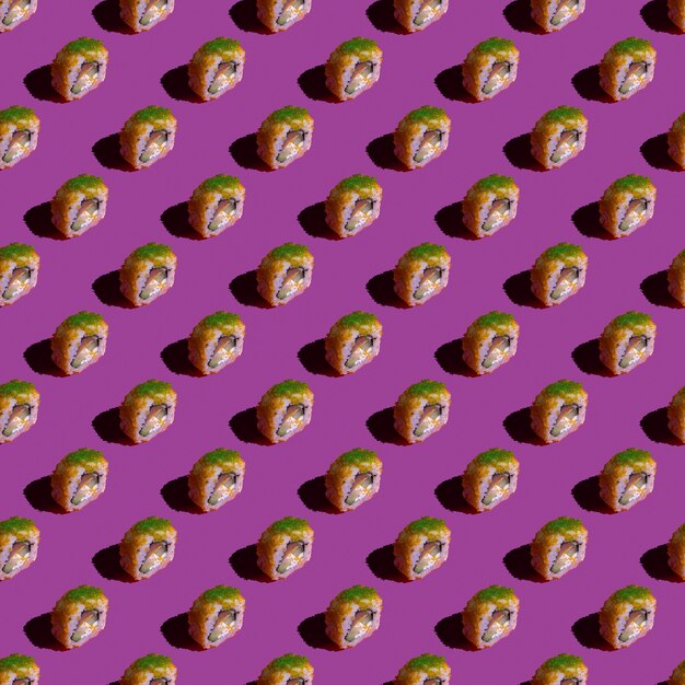 Photo yellow sushi seamless pattern. made in a flat style on a pink background.