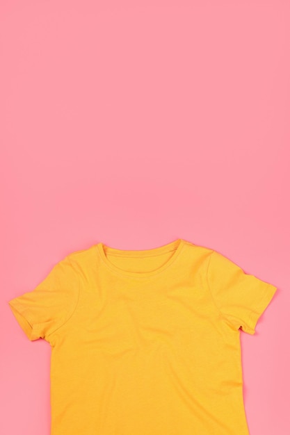 Yellow t-shirt with space for print on pink background