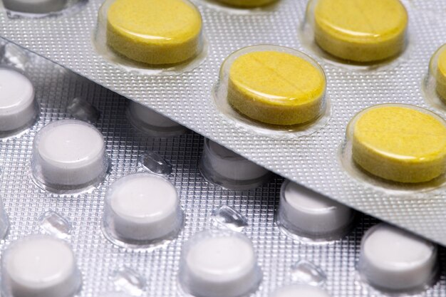 Yellow tablets in a close-up blister. medical drug