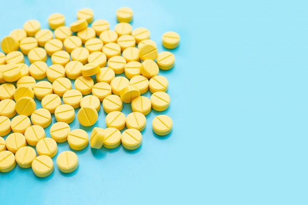 Yellow tablets of Paracetamol on blue