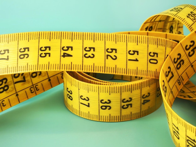 A yellow tailor measuring tape measure